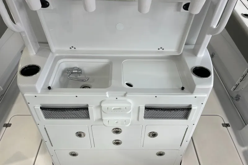 Slide: The Image of 2025 Sportsman Open 282 Center Console boat interior with sink and storage compartments. - 17
