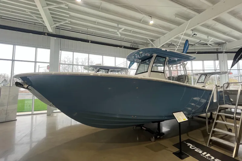 Slide: The Image of 2025 Sportsman Open 282 Center Console boat displayed in a showroom. - 23