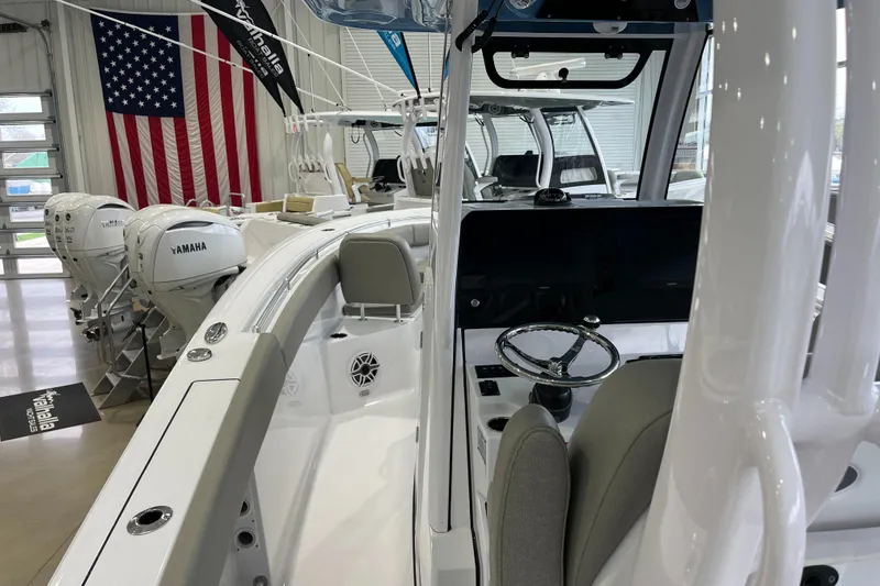 Slide: The Image of 2025 Sportsman Open 282 Center Console boat interior with Yamaha engines in showroom. - 4