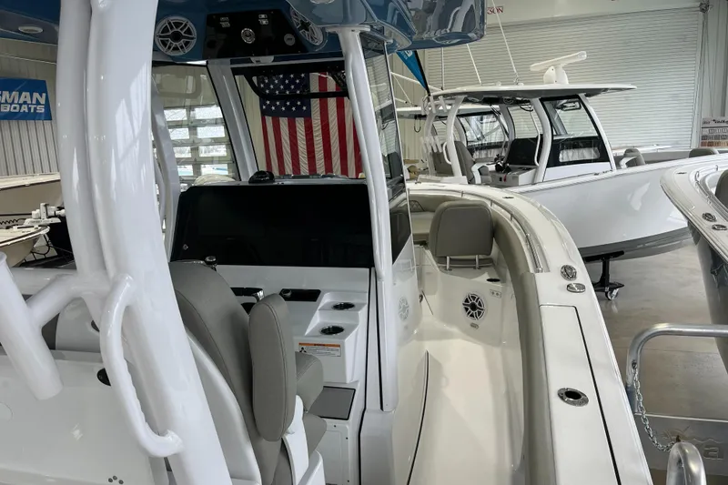 Slide: The Image of 2025 Sportsman Open 282 Center Console boat in showroom, featuring sleek design and modern amenities. - 5
