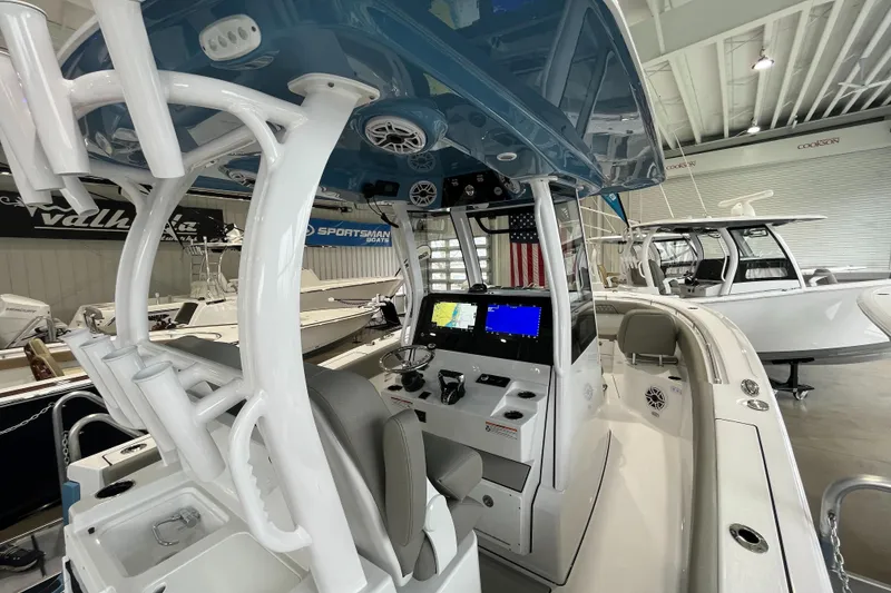 Slide: The Image of 2025 Sportsman Open 282 Center Console boat interior with navigation screens and seating. - 7
