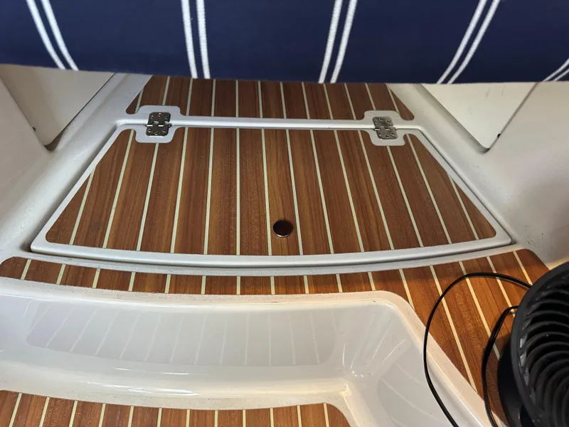 Slide: The Image of Teak deck of 2015 Wellcraft 290 Coastal boat with striped seating. - 13