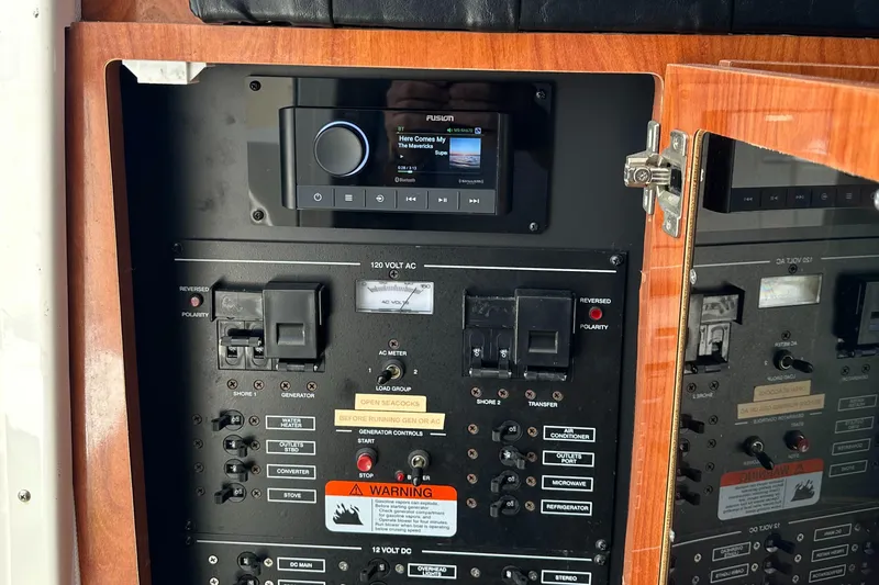 Slide: The Image of Control panel of a 2015 Wellcraft 290 Coastal boat with audio system and switches. - 17