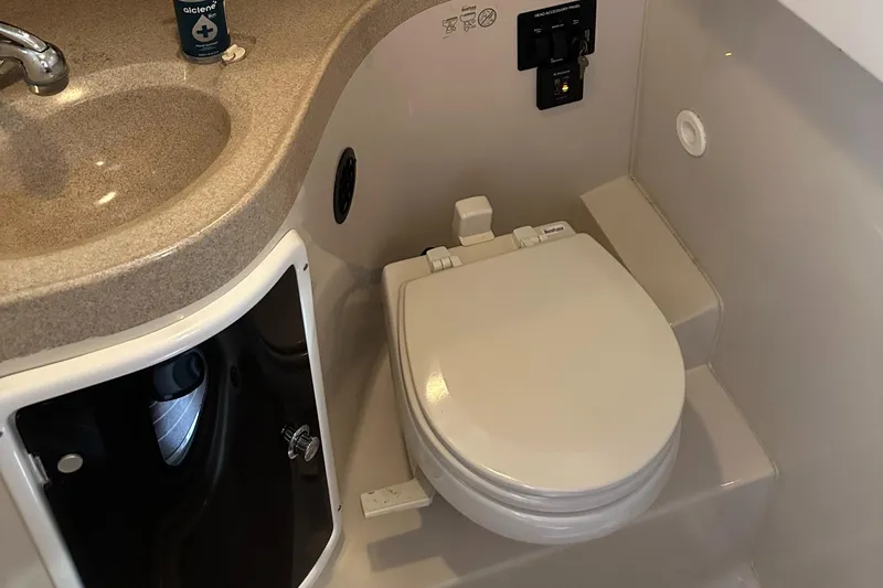 Slide: The Image of 2015 Wellcraft 290 Coastal boat bathroom with sink and toilet. - 18