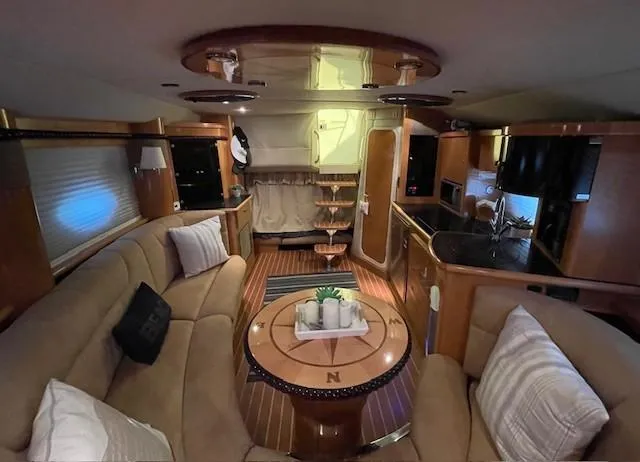 Slide: The Image of Interior of 2008 Larson Cabrio 330 Day Cruiser with elegant seating and wooden finishes. - 10