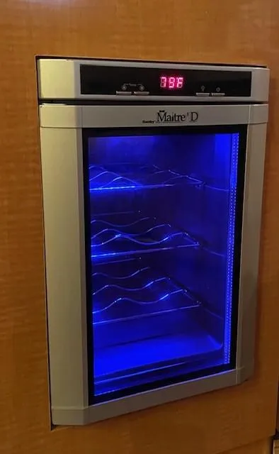Slide: The Image of Built-in wine cooler with blue LED lighting in a 2008 Larson Cabrio 330 Day Cruiser. - 12
