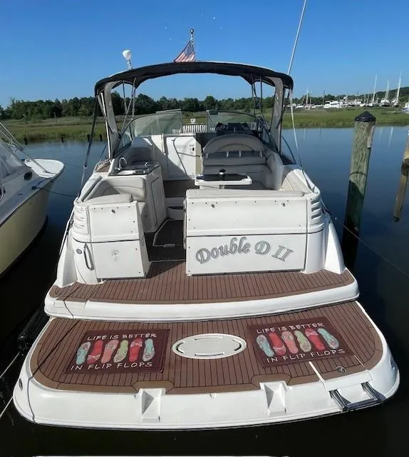 Slide: The Image of 2008 Larson Cabrio 330 Day Cruiser docked, featuring "Double D II" and flip-flop themed deck. - 3