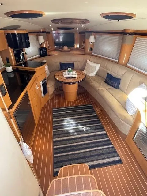Slide: The Image of 2008 Larson Cabrio 330 Day Cruiser interior with cozy seating and modern kitchen amenities. - 5