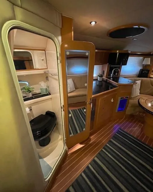 Slide: The Image of Interior of 2008 Larson Cabrio 330 Day Cruiser with kitchenette and bathroom. - 6