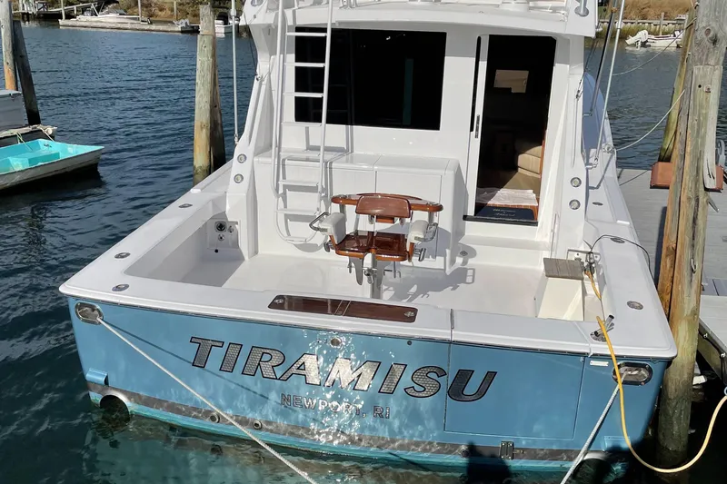 Slide: The Image of 1996 Viking 47 Convertible boat named Tiramisu docked at a marina. - 1