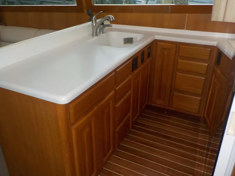 Slide: The Image of Wooden kitchen area in 1996 Viking 47 Convertible yacht with white countertop. - 10