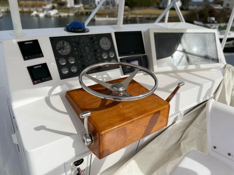 Slide: The Image of Steering console of a 1996 Viking 47 Convertible yacht with modern navigation instruments. - 16