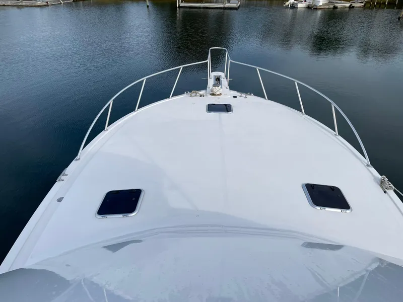Slide: The Image of 1996 Viking 47 Convertible yacht bow view on calm water. - 2