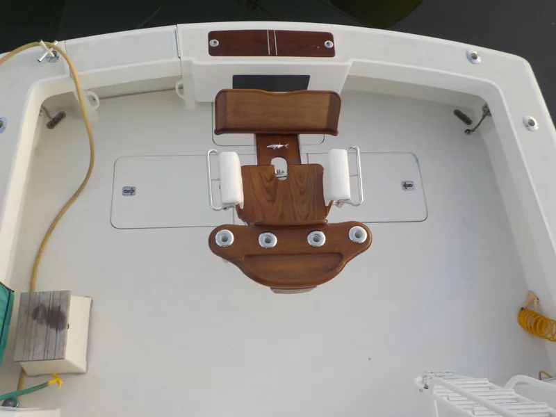 Slide: The Image of 1996 Viking 47 Convertible boat deck with wooden fittings and fishing chair. - 21