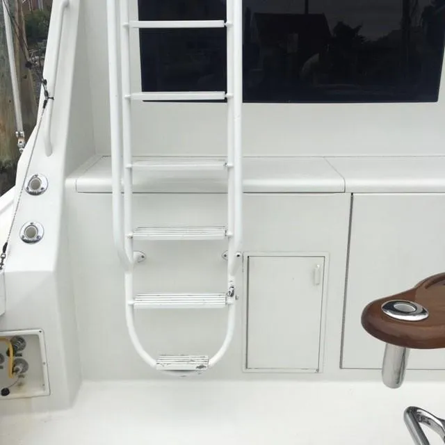 Slide: The Image of White ladder and deck area on 1996 Viking 47 Convertible yacht. - 23