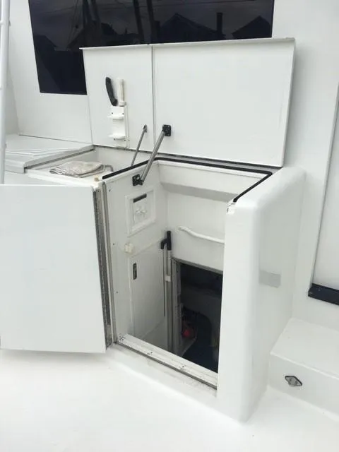 Slide: The Image of 1996 Viking 47 Convertible yacht interior access hatch, open and white. - 25