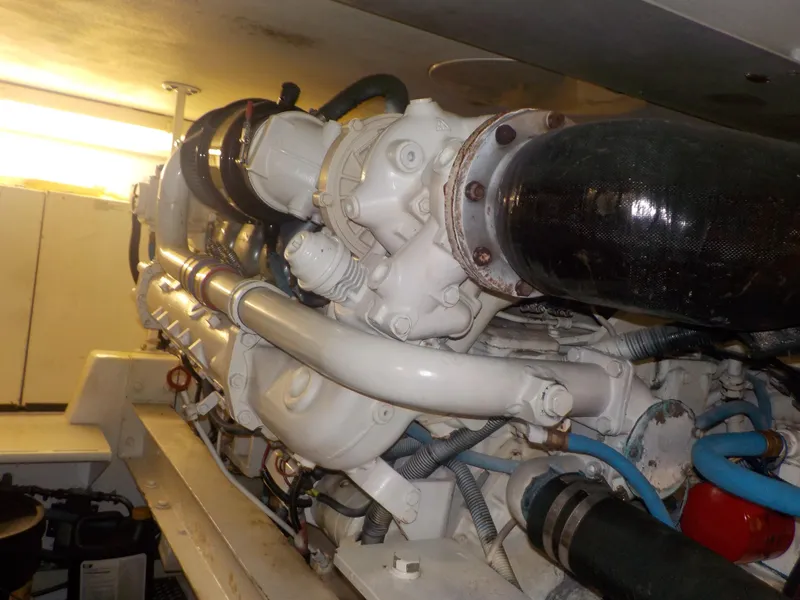 Slide: The Image of Engine room of 1996 Viking 47 Convertible yacht, showcasing detailed machinery and components. - 28