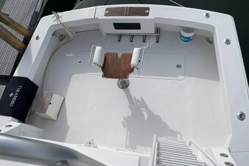 Slide: The Image of 1996 Viking 47 Convertible boat deck with fishing chair and clean white surface. - 3