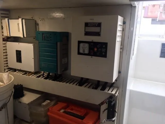Slide: The Image of Electrical panel inside 1996 Viking 47 Convertible boat, featuring various control units and equipment. - 33