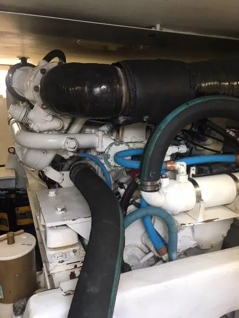 Slide: The Image of Engine room of 1996 Viking 47 Convertible yacht with visible hoses and components. - 34