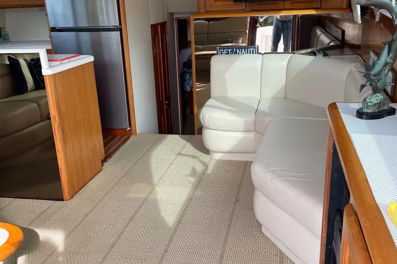 Slide: The Image of Interior of 1996 Viking 47 Convertible yacht with white leather seating and modern kitchen. - 7