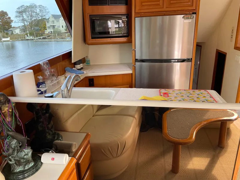 Slide: The Image of Interior of 1996 Viking 47 Convertible yacht with kitchen and seating area. - 9
