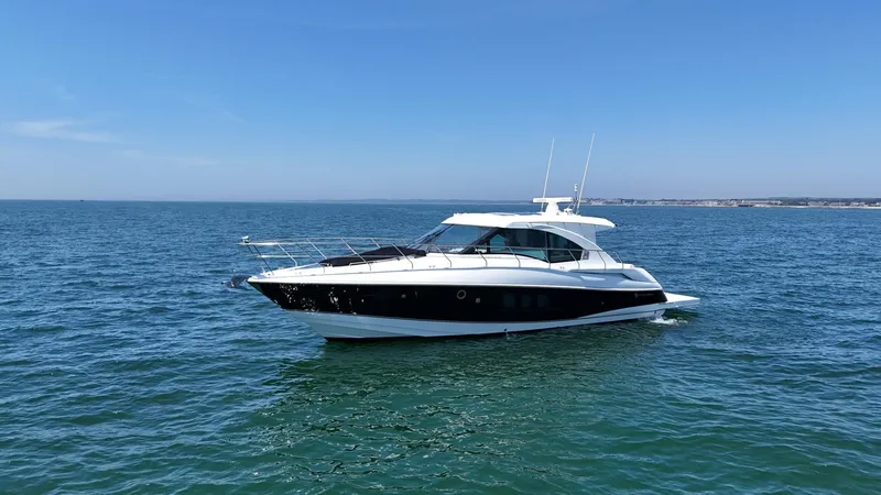 The Image of 2015 Cruisers Yachts 45 Cantius on open water under clear blue sky. - 0
