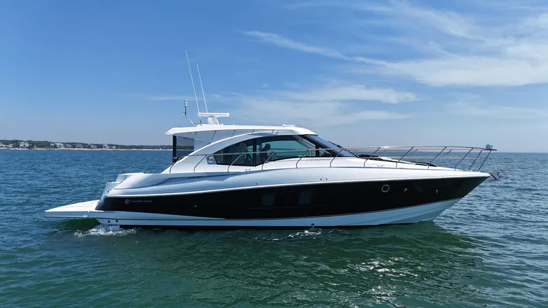 Slide: The Image of 2015 Cruisers Yachts 45 Cantius on open water under clear blue sky. - 2