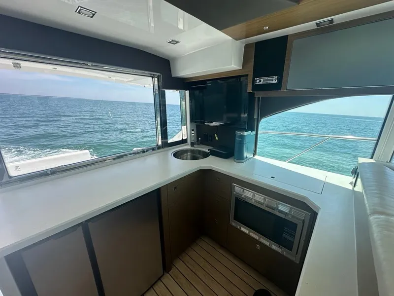 Slide: The Image of Luxurious 2015 Cruisers Yachts 45 Cantius kitchen with ocean view, featuring modern appliances. - 26