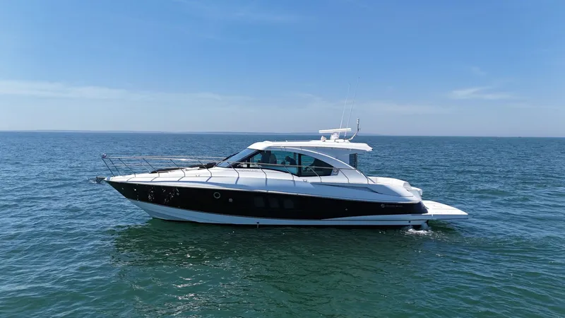 Slide: The Image of 2015 Cruisers Yachts 45 Cantius on open water under clear blue sky. - 4