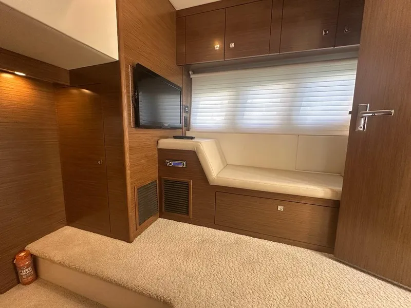Slide: The Image of Interior of 2015 Cruisers Yachts 45 Cantius with seating, TV, and wood paneling. - 45
