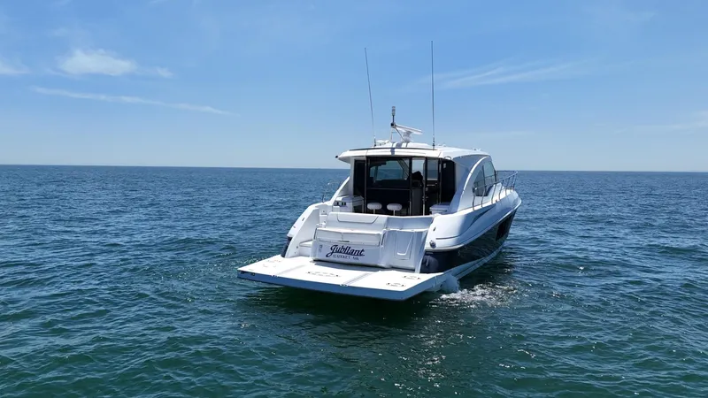 Slide: The Image of 2015 Cruisers Yachts 45 Cantius on open water under clear blue sky. - 5