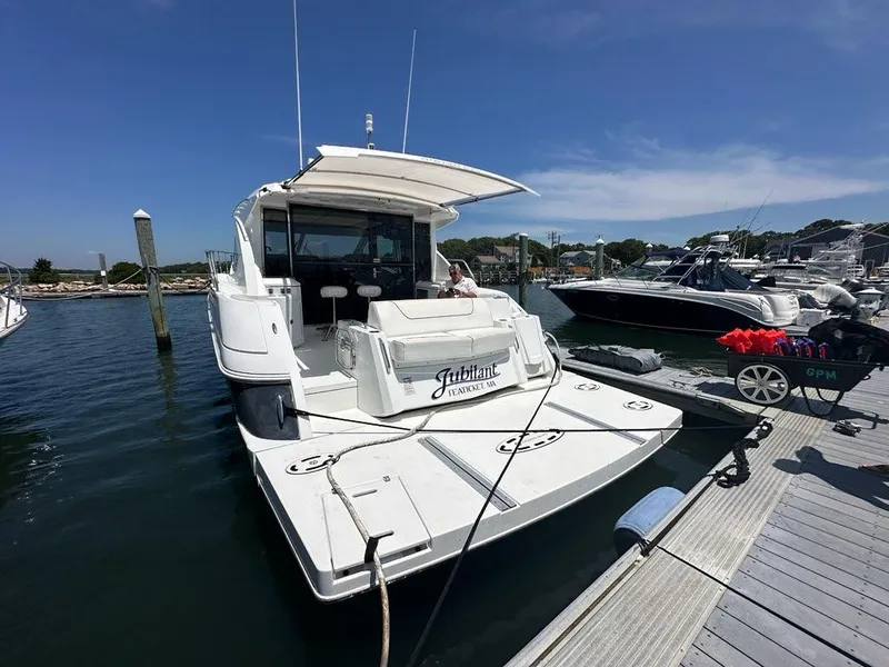 Slide: The Image of 2015 Cruisers Yachts 45 Cantius docked at marina under clear blue sky. - 11