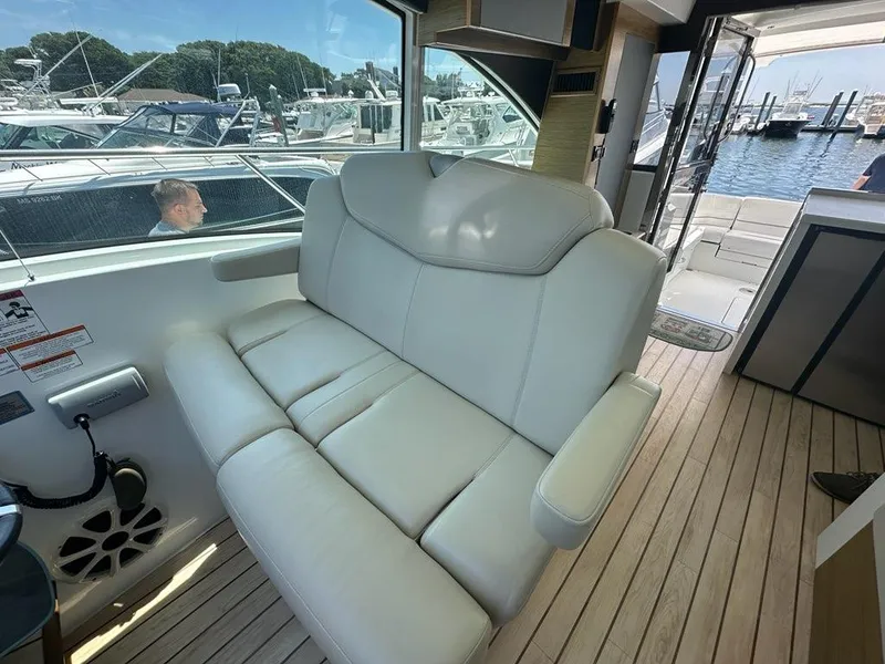 Slide: The Image of Luxurious interior of 2015 Cruisers Yachts 45 Cantius with leather seating and marina view. - 19