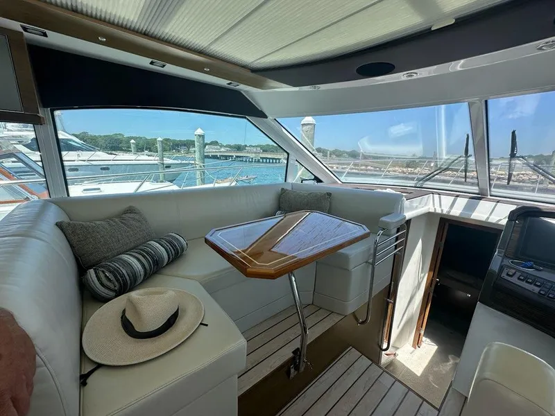 Slide: The Image of Interior of 2015 Cruisers Yachts 45 Cantius with seating and table, dock view. - 22