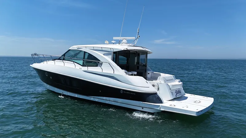 Slide: The Image of 2015 Cruisers Yachts 45 Cantius on open water under clear blue sky. - 3