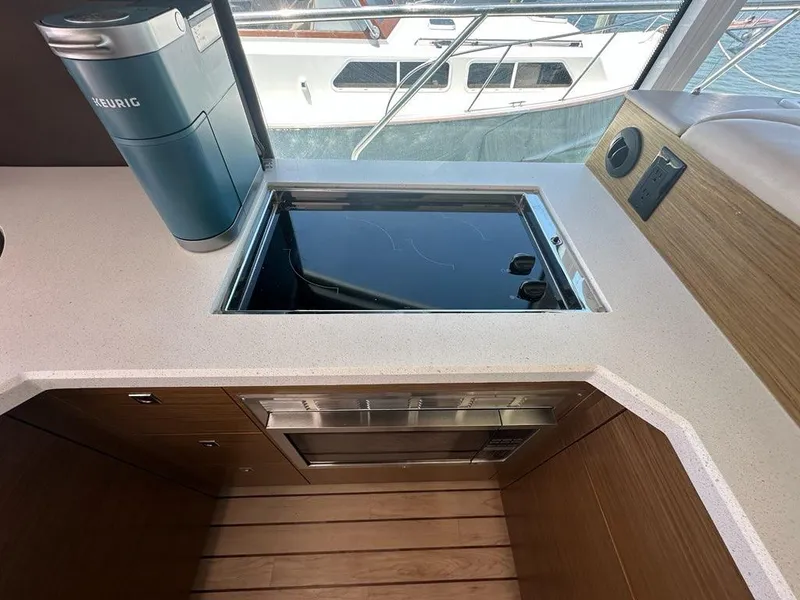 Slide: The Image of Modern kitchen area on 2015 Cruisers Yachts 45 Cantius with stove and coffee maker. - 30
