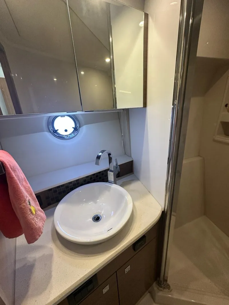 Slide: The Image of Luxurious bathroom in 2015 Cruisers Yachts 45 Cantius with modern sink and mirror. - 43