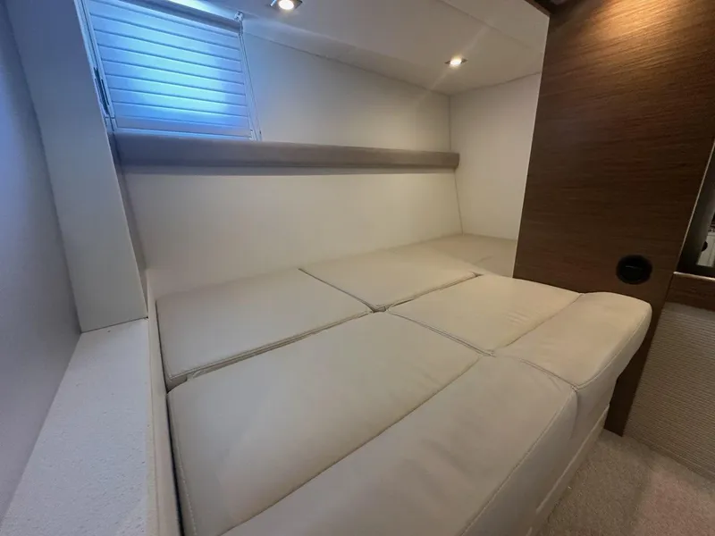 Slide: The Image of Interior cabin of 2015 Cruisers Yachts 45 Cantius with beige seating and wood accents. - 49