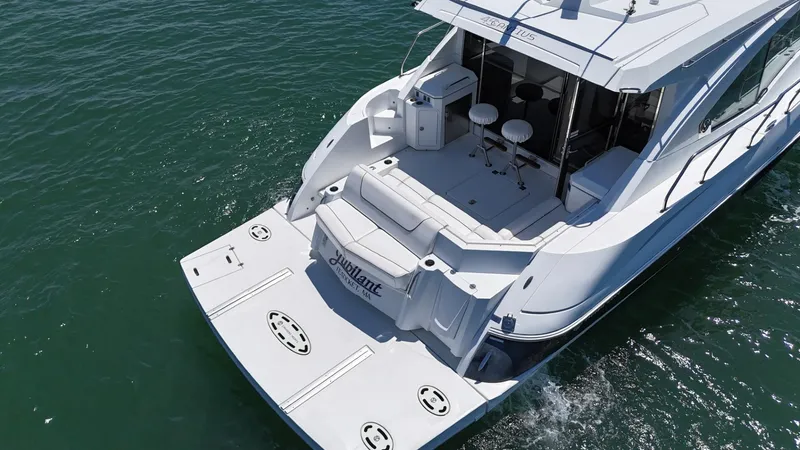 Slide: The Image of 2015 Cruisers Yachts 45 Cantius on water, featuring spacious deck and seating area. - 6