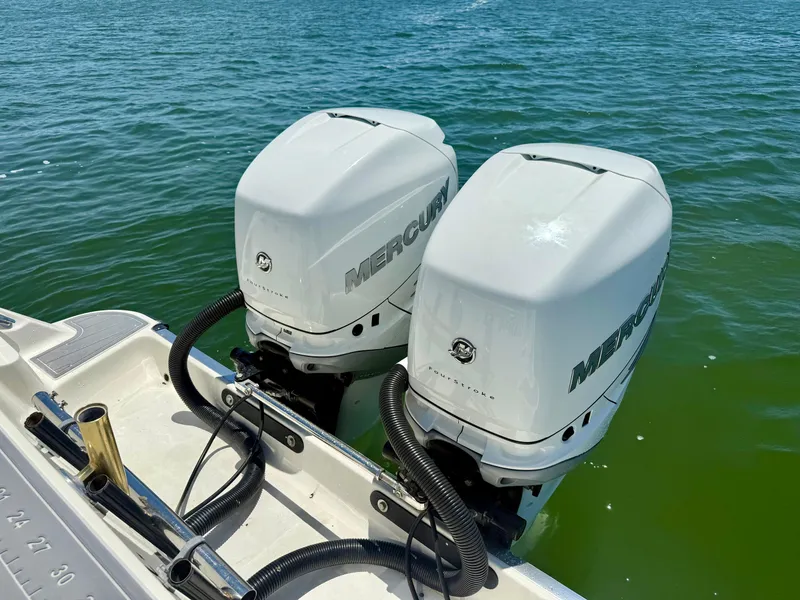 Slide: The Image of Twin Mercury outboard engines on a 2006 Hydra-Sports Vector VX boat in water. - 12