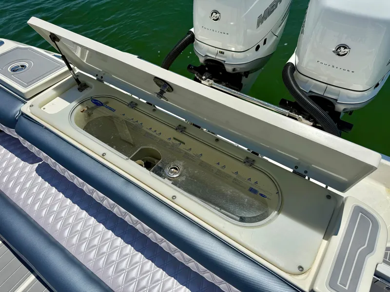 Slide: The Image of 2006 Hydra-Sports Vector VX boat with open storage compartment and twin Mercury FourStroke engines. - 13