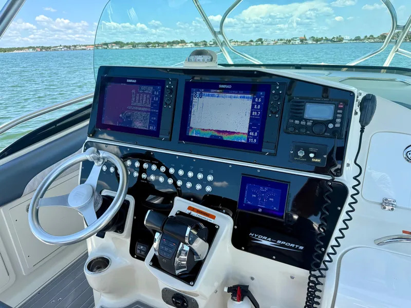 Slide: The Image of 2006 Hydra-Sports Vector VX boat dashboard with navigation screens and steering wheel. - 15
