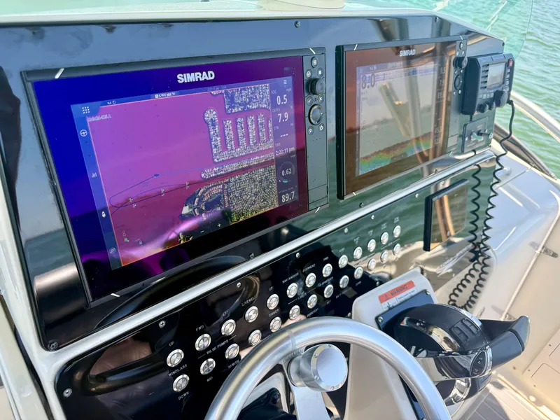 Slide: The Image of 2006 Hydra-Sports Vector VX boat dashboard with Simrad navigation displays and controls. - 16