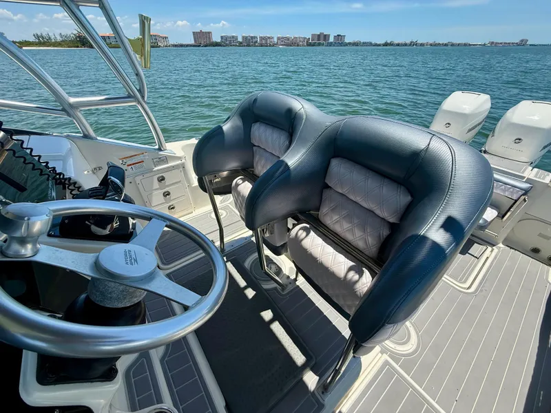 Slide: The Image of 2006 Hydra-Sports Vector VX boat interior with steering wheel and cushioned seats. - 19