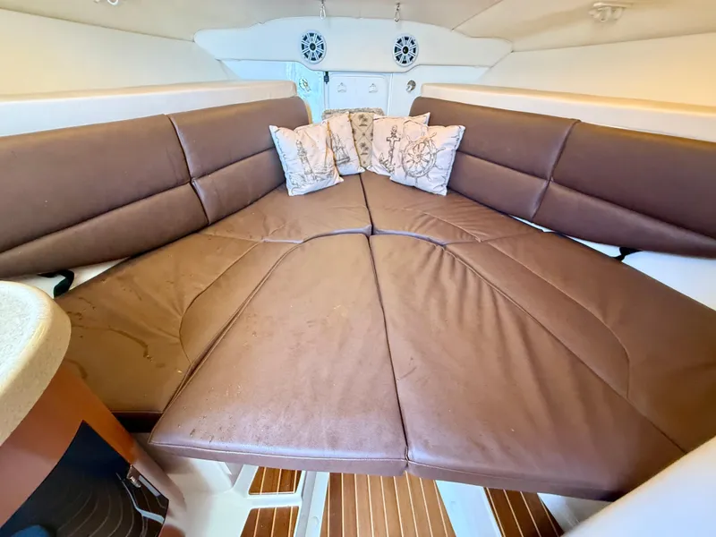 Slide: The Image of 2006 Hydra-Sports Vector VX cabin interior with brown cushions and decorative pillows. - 26