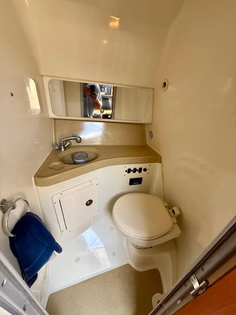 Slide: The Image of 2006 Hydra-Sports Vector VX boat bathroom with sink, toilet, and mirror. - 28