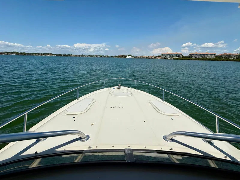 Slide: The Image of 2006 Hydra-Sports Vector VX boat cruising on a calm lake under a clear blue sky. - 34