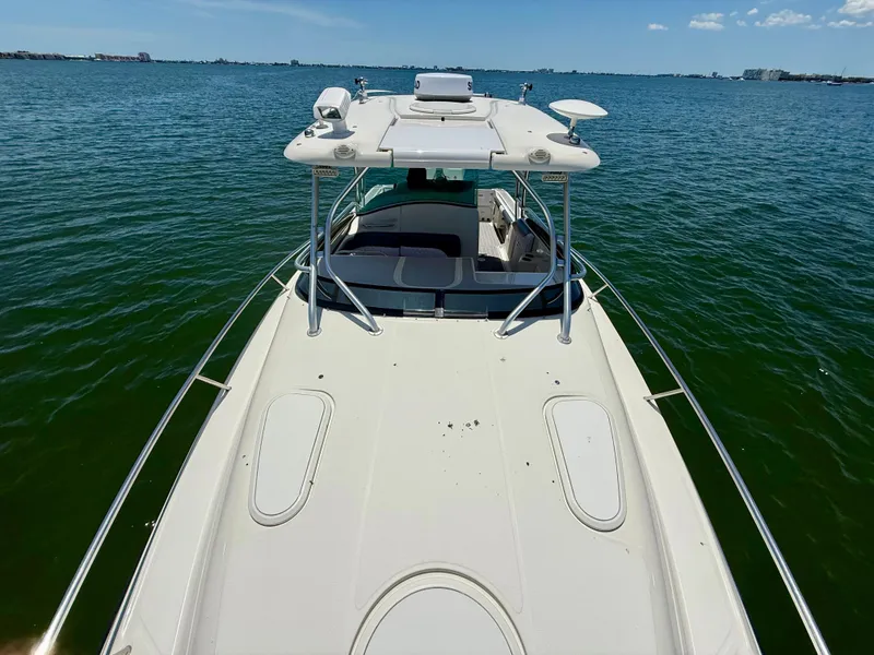 Slide: The Image of 2006 Hydra-Sports Vector VX boat on calm water, clear sky in background. - 36