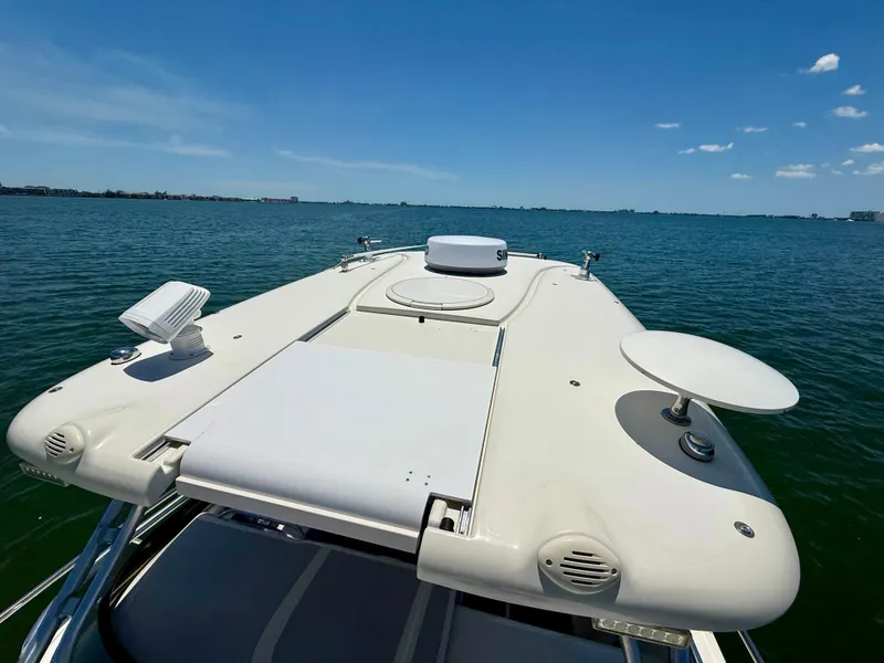 Slide: The Image of 2006 Hydra-Sports Vector VX boat deck on calm water under clear blue sky. - 37